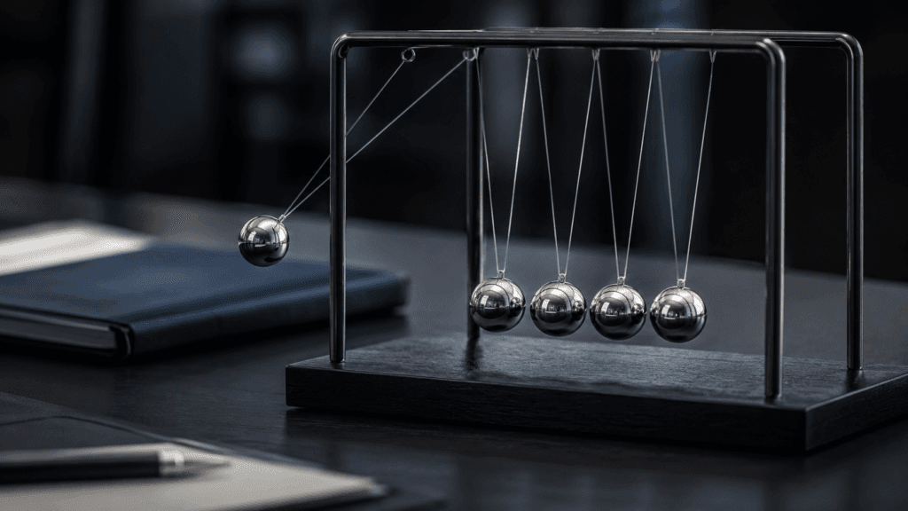 Newton's cradle with one metal ball lifted to the side