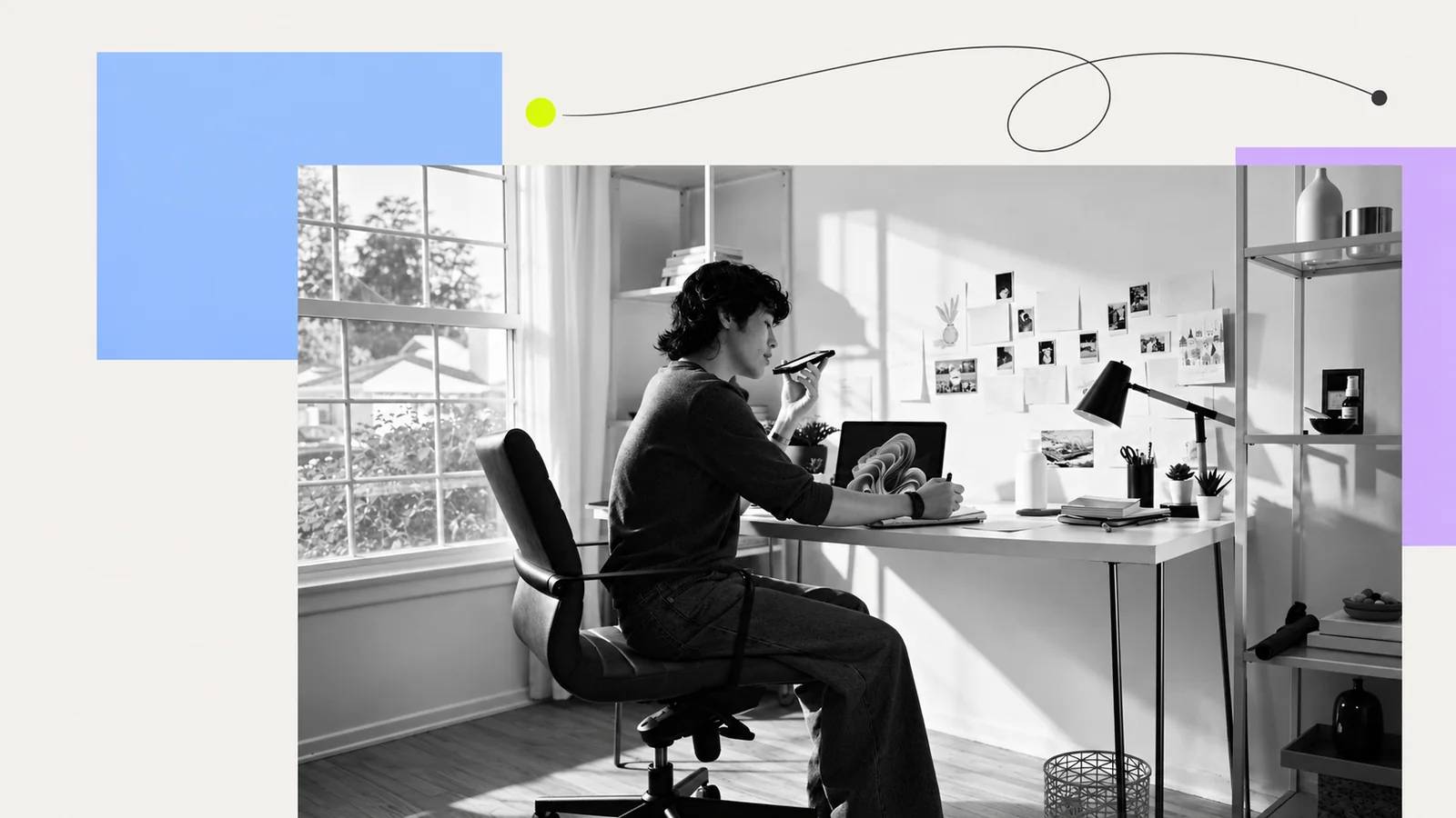 A person using a phone while writing in a notebook at a desk.