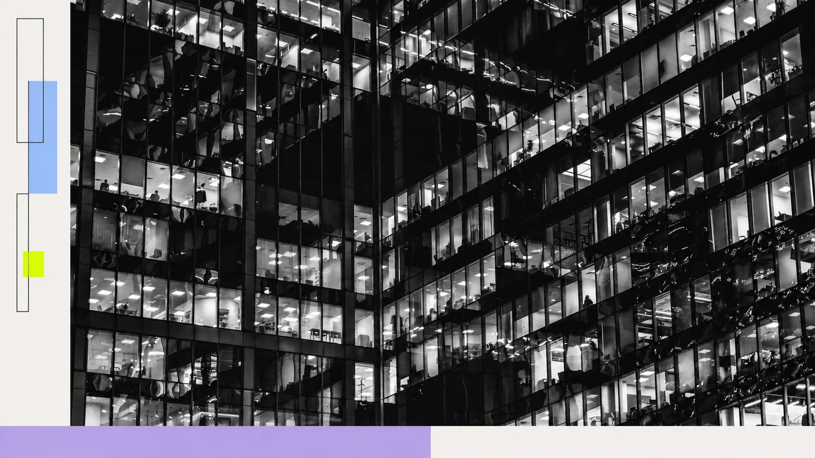 Illuminated office windows against a dark building.