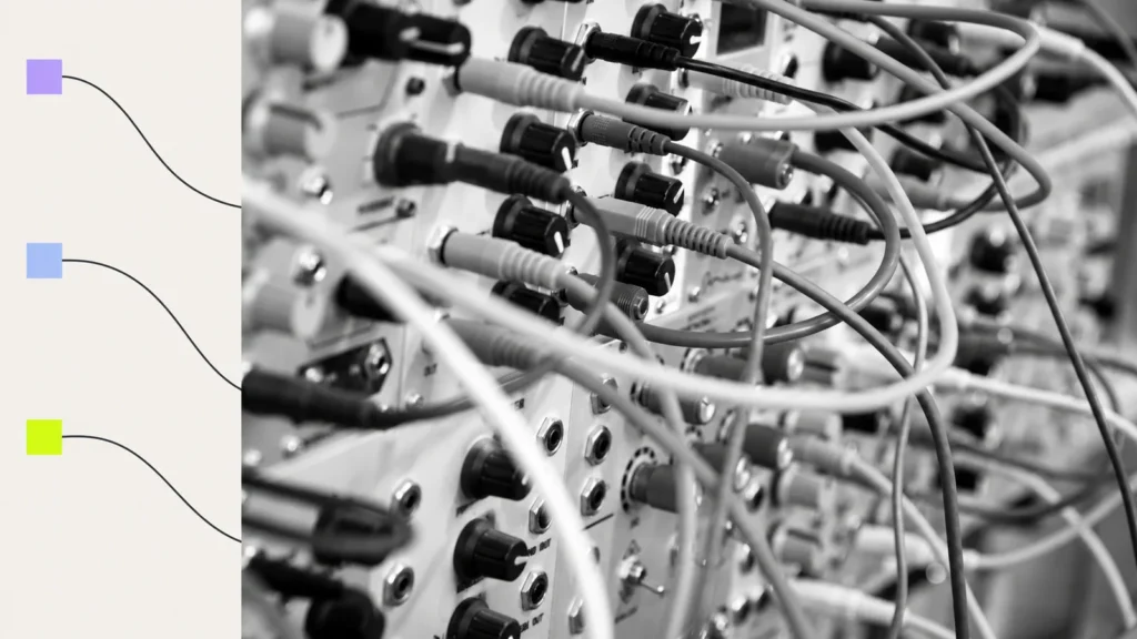 Patch cables connecting sockets on a modular panel.