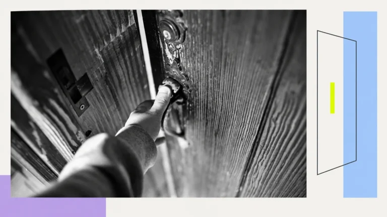 A hand opening a wooden door.