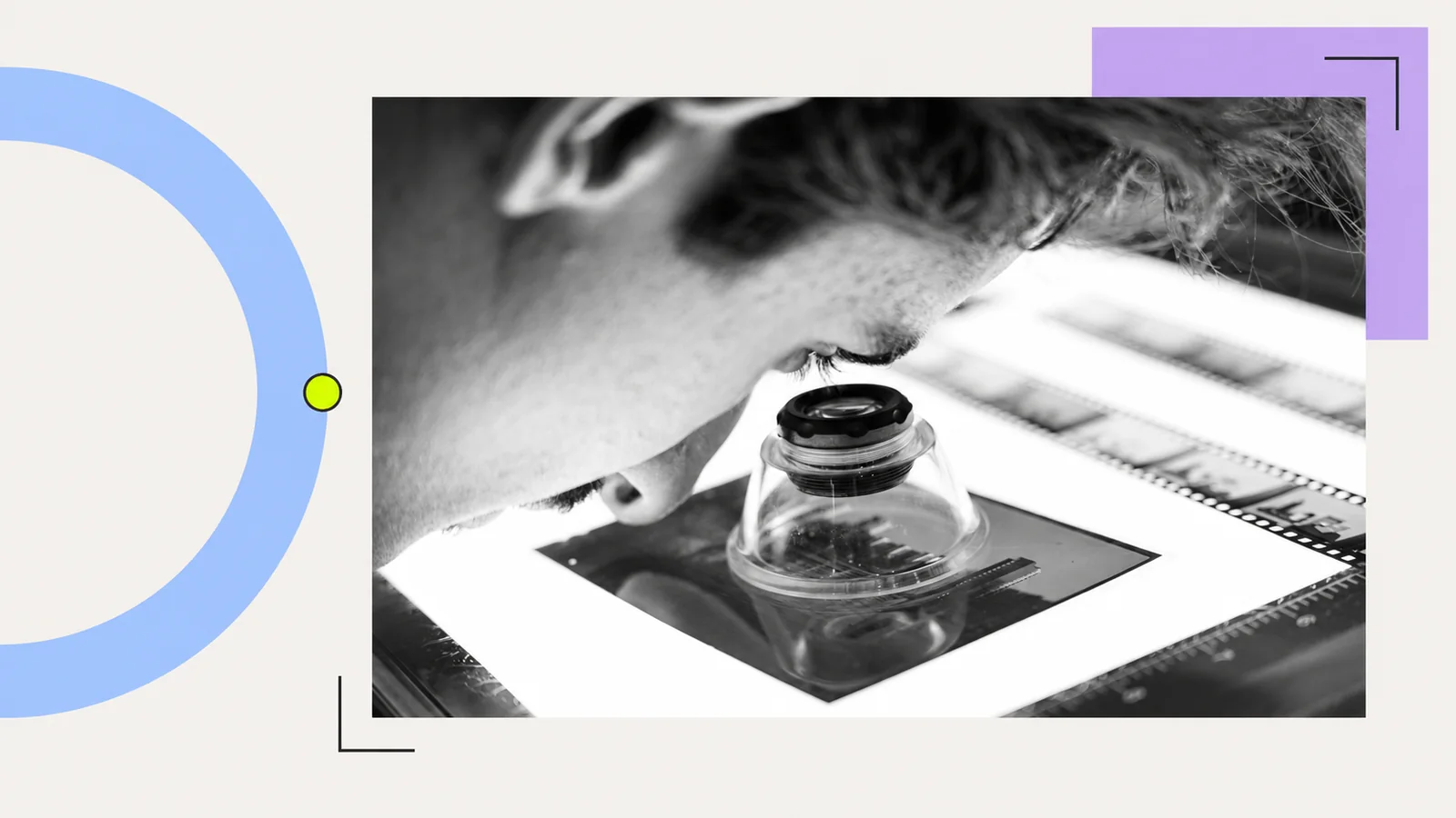 A person examining photographic film through a loupe.