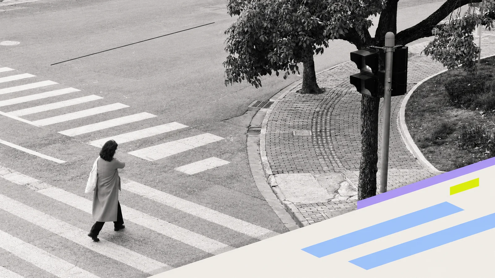 A lone pedestrian crossing a marked street.